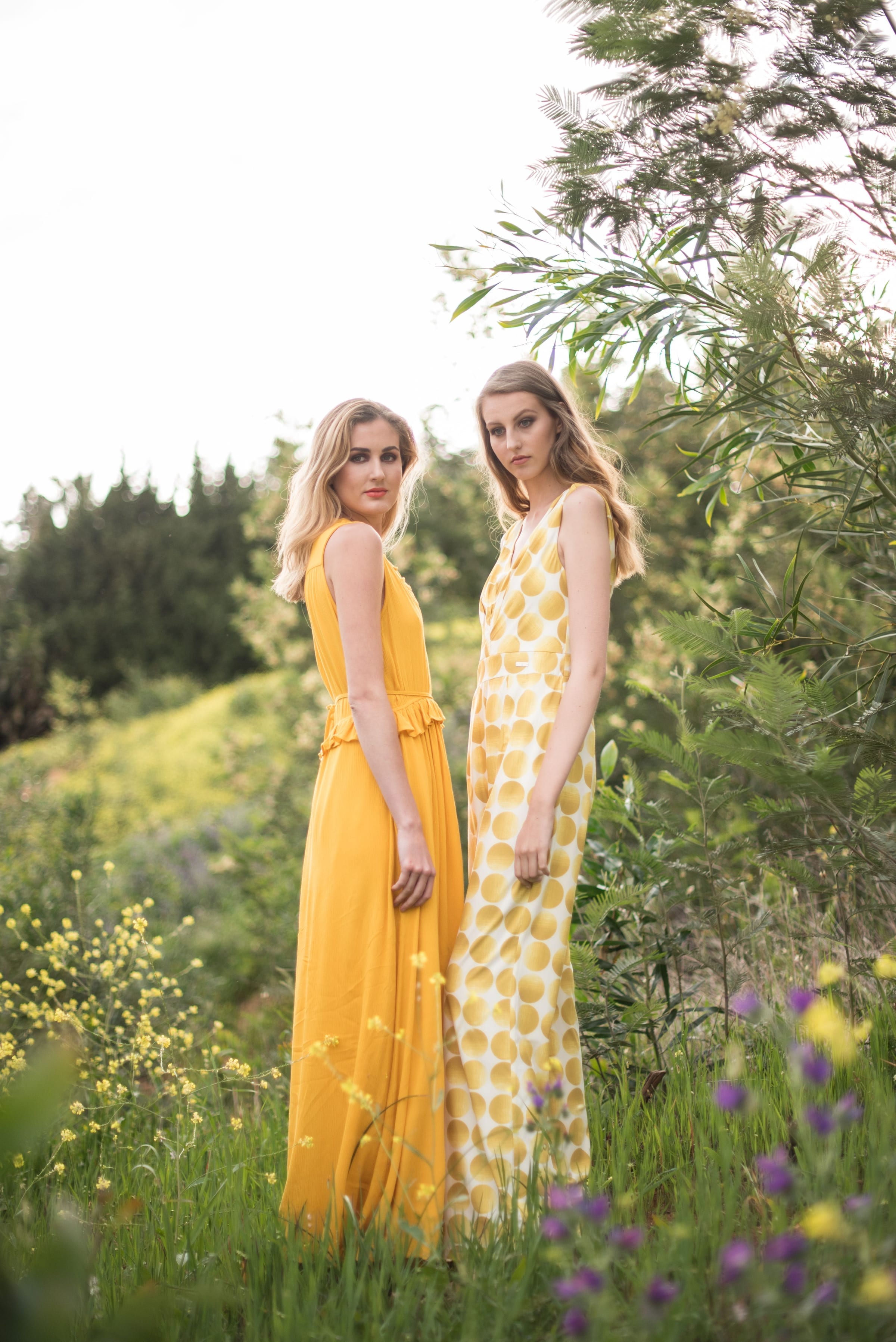 Fashion photography - Two models in yellow dresses in wildflower meadow