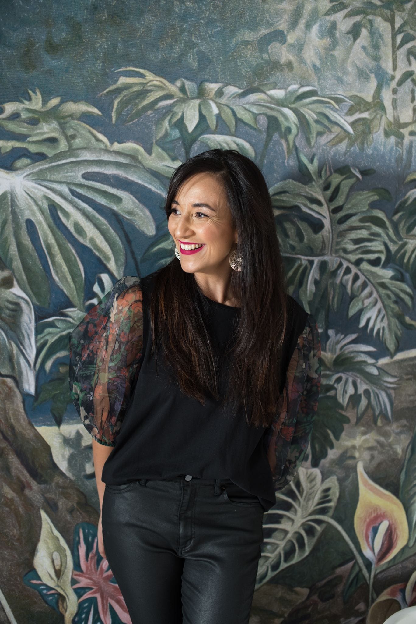 Woman laughing against a tropical botanical background — natural portrait photography in Cape Town by Jeanne Taylor